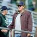 Former Michigan head coach Lloyd Carr greets a fan while entering the stands during the Eastern Michigan, Western Michigan football game at Rynearson Stadium on Saturday afternoon. Melanie Maxwell I AnnArbor.com